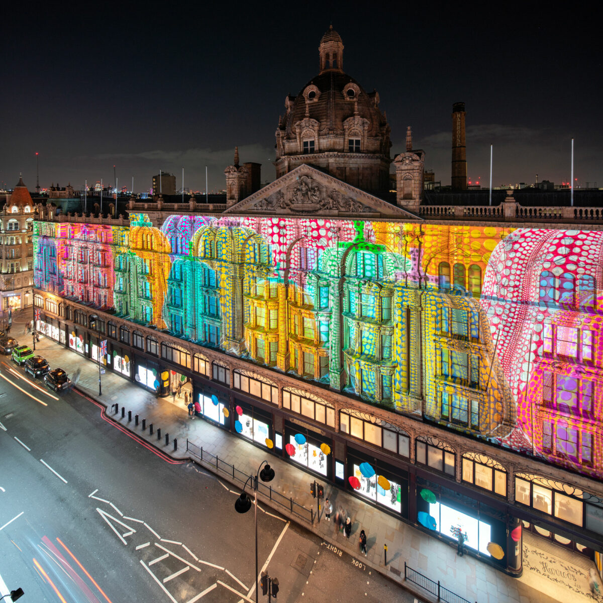 Louis Vuitton has celebrated a collaboration with Yayoi Kusama by projecting the artist's designs onto the façade of Harrods - a media first.