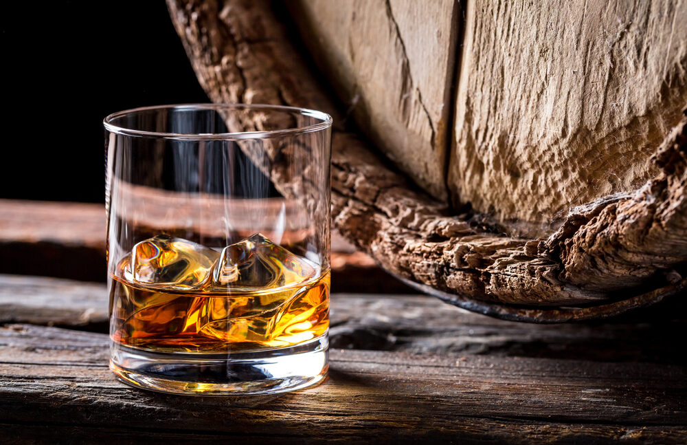 Whisky industry leaders are concerned about a Scottish government report that suggests banning the sale of alcohol-branded merchandise.