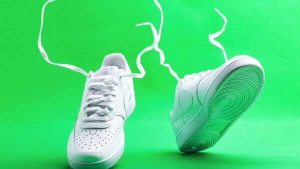 Flying white sneaker Nike on green background