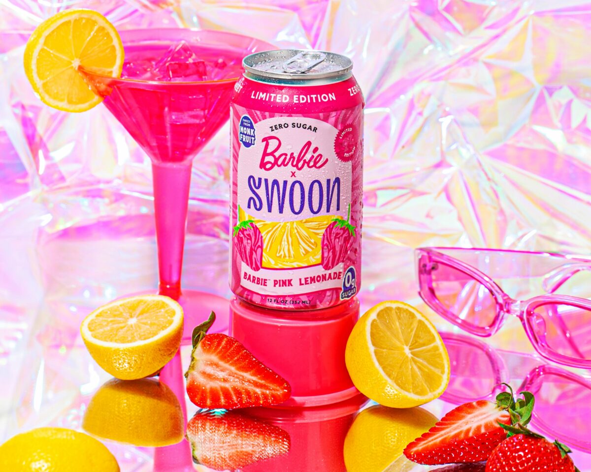 Swoon has released Barbie themed lemonade, seen here in a themed can and surrounding by lemons and strawberries.