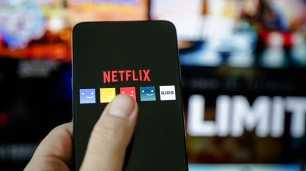 Depicting Netflix streaming platform and a phone displaying different user icons- Netflix held talks with global advertising executives at Cannes to explore different advertising formats in a bid to boost advertising revenues.