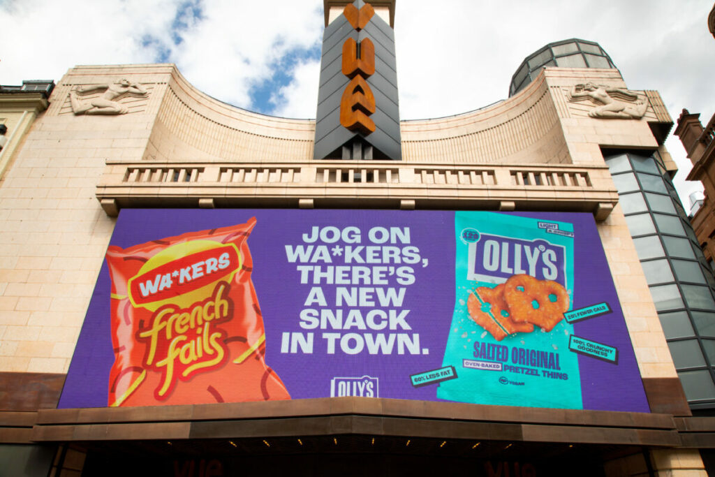 London-based snack brand Olly's has staged a 'war' against the competitive crisp brand, Walkers, calling them 'Wa*kers' in their latest campaign, depicted here