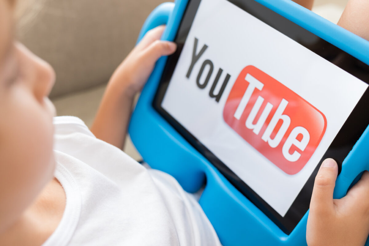 YouTube has come under fire for running brands' adverts on kid's channels, which is believed to have led to the tracking and harvesting of children's data, the photo here depicting a child watching YouTube