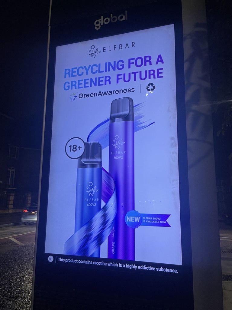 The Advertising Standards Authority is reviewing complaints that disposable vape brand Elfbar adverts, showcased on the Transport for London's network are giving out a 'misleading' environmental message. the brand's adverts, which are displayed as out-of-home (OOH) statics on some buses and bus stops in London, feature the words "Recycling for a greener future". However, complainants have claimed the Elfbar e-cigarettes are in fact not recyclable, a claim that has been supported by councils and environmental groups.  In response, the London transport network said it has worked with advertisers to ensure all campaigns fell within TfL's advertising rules. In addition, Elfbar claimed that its adverts were actually aiming to create awareness that e-cigarettes must be properly disposed of. Yet the environmental campaign movement, Greenpeace has called the adverts, 'blatant attempt to bath an environmental menace in a thin veneer of greenwash". Discussing the advert, Greenpeace plastic campaigner, Anna Diski, added: "The truth is these products are one of the new defining images of our single-use throwaway culture. "What other piece of tech is designed to be thrown away so quickly? Despite any claims to the contrary they're close to impossible to recycle." The contentious adverts follow in the wake of tightening marketing surrounding the e-cigarette industry. Earlier this year, the government introduced a ban on a promotional loophole that allowed vape brands to legally offer e-cigarettes to children. It is also not the first campaign from Elfbar that has been investigated by the ASA. Last year, adverts from the vape brand were banned for promoting to children, while this year, two Elfbar TikTok adverts were banned for breaching nicotine and age-related ad codes. A TfL spokesperson said it worked with advertisers to "ensure any e-cigarette campaign running on our estate complies with the latest rules by the ASA and has appropriate messaging". The ASA said: "Our rules make it clear that any claims in ads, including green claims, need to be backed up by sufficient evidence." Elfbar told the BBC it had introduced more recycling facilities and was trying to actively encourage recycling through it's creative campaigns, depicted here.