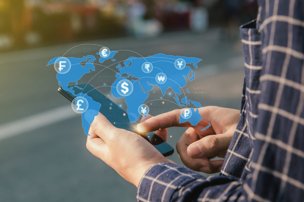 Global ad spend is forecasted to grow a further 8.2% in 2024 as expenditure tops $1 trillion (£786.8 million) for the first time, a new WARCreport has found, here depicting a blue global map with different currency signs