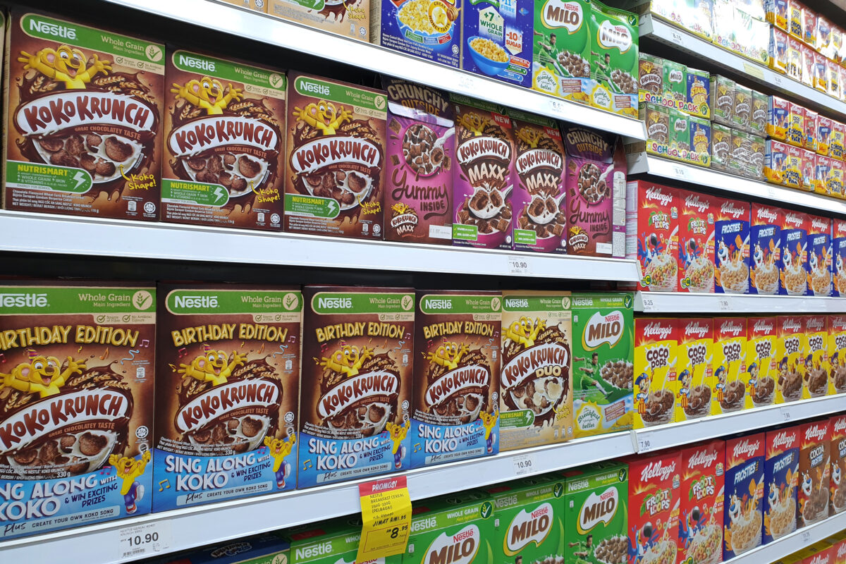 A photo showing an example of Nestle and other brand's sugary cereal items, with vibrant colours, animations and brand characters