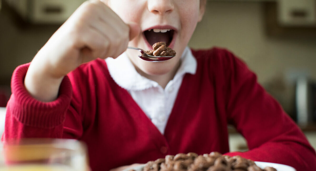 The health group Action for Sugar has called for breakfast cereals and yoghurts high in fat, sugar and salt (HFSS) to remove any packaging that could appeal to children, depicted here with a child eating a sugary cereal