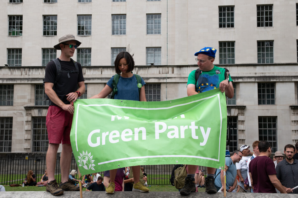 The Green Party has voted to ban 'High Carbon Advertising' following a motion put forward by MP Caroline Lucas at the party's conference, green party supporters with a green banner depicted here
