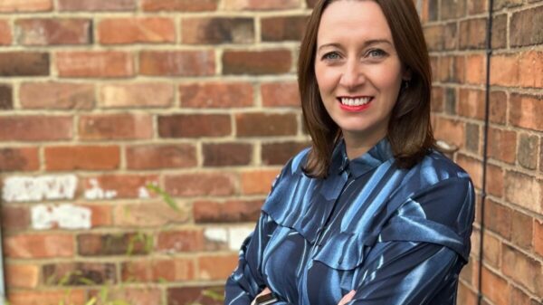Marketing agency M&C Saatchi TALK has expanded its senior leadership team, announcing Hannah Wallace as its new business director., Wallace depicted here in a blue shift smiling against a brick background