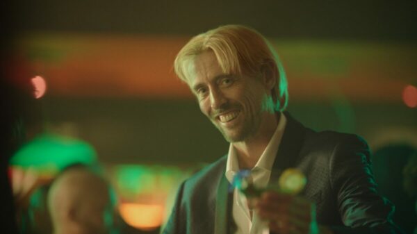 Paddy Power Games is reimagining a "Life with more chances" in its latest ad, giving viewers a glimpse of a reality with alternative scenarios, here depicting Peter Crouch in a blonde wig and in a bar setting