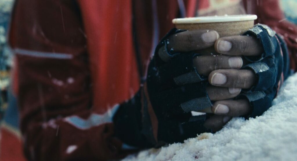 Image of a Royal Mail worker with gloved hands in the snow. The Royal Mail has unveiled a major new campaign celebrating the hands-on work of posties to coincide with the busy festive period, with the end line ‘In Good Hands’.