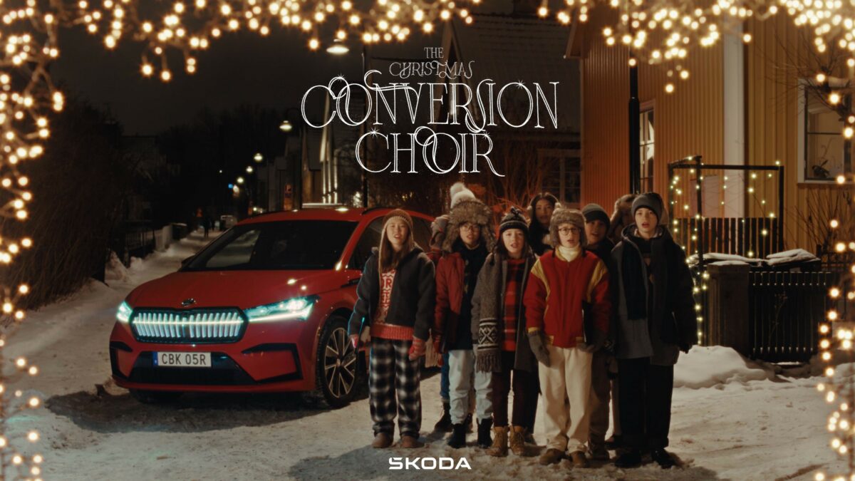 Carol singing choir pictured next to Škoda vehicle.In a festive campaign car brand Škoda puts a spotlight on the role of carols in evoking the spirit of Christmas.