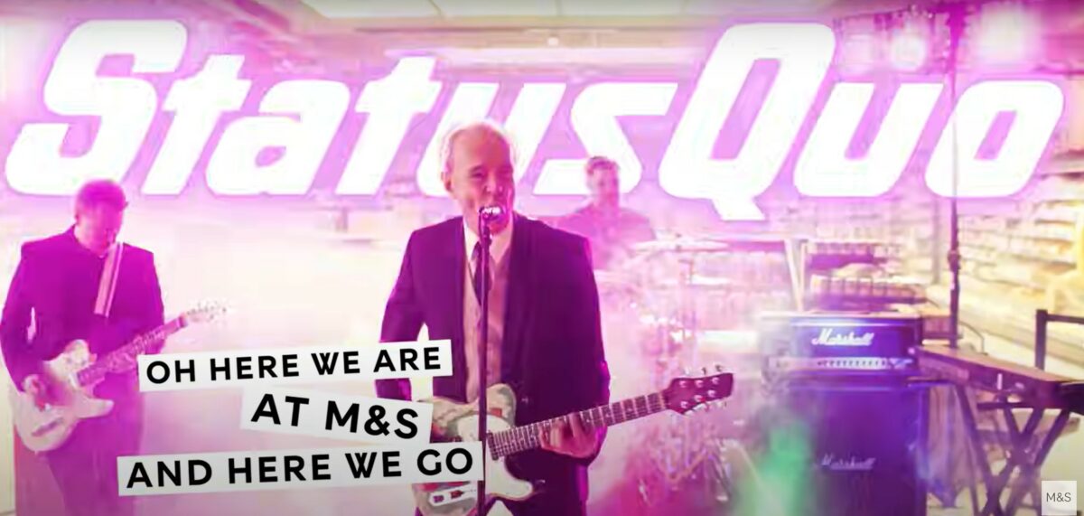 Snap from M&S status quo video. M&S Food has rewritten the Status Quo hit Rockin All Over the World, jazzing up the lyrics to highlight in-store savings, launched across socials.