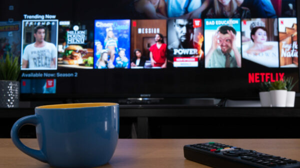 Netflix on a living room tv screen. Netflix's ad-supported tier has surpassed 23 million global active users per month, the figure comes just one year after the streamer launched it.