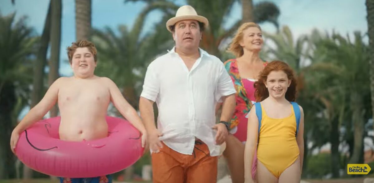 Screenshot from On the Beach campaign featuring family of four at the beach. On the Beach Holidays has hit back at comments about its campaign which it deemed "fattist" and "snobby".