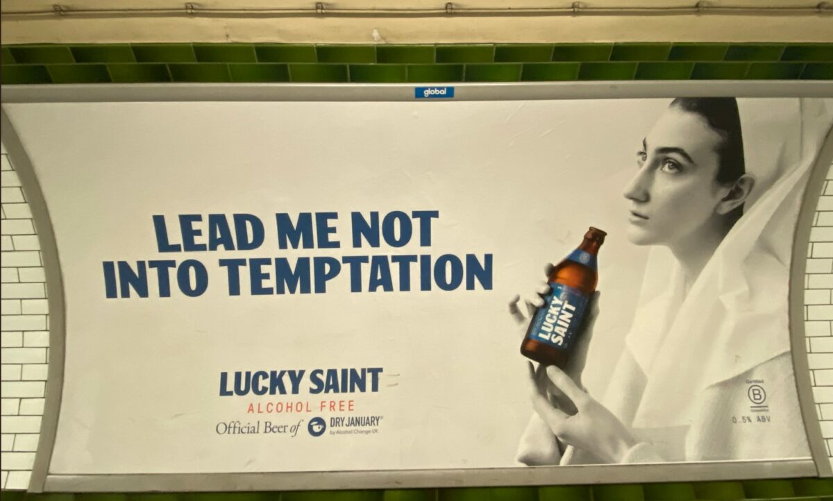 Lucky Saint dry January campaign featuring words "Divine intervention" and religiously symbolic hands with Lucky Saint Bottle. As consumers it is easy to see January as a time to start a clean slate, but how are the best marketers breaking the mould and thinking beyond?