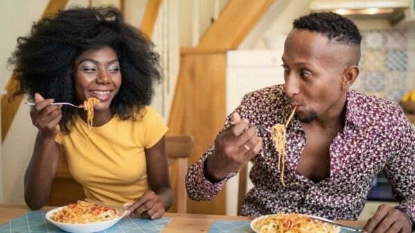 Couple eating Dolmio pasta. Dolmio has partnered with TikToker Jacob Lucas to share etiquette tips for ultimate dinner dates.