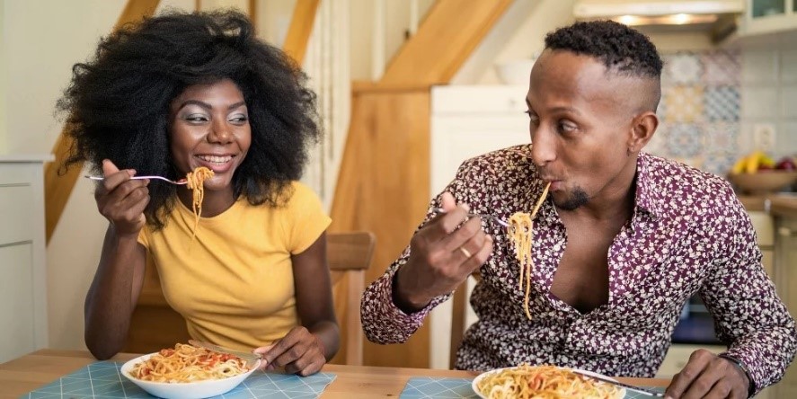 Couple eating Dolmio pasta. Dolmio has partnered with TikToker Jacob Lucas to share etiquette tips for ultimate dinner dates.