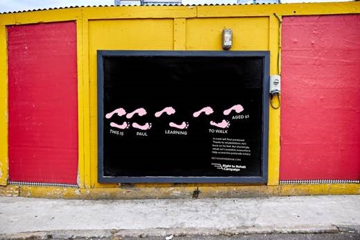 Pablo rehabilitation billboard showing painted feet illustrating first steps of rehabilitation patients. Pablo has launched a major new billboard and digital radio campaign which calls for an end to the postcode lottery for rehabilitation services.