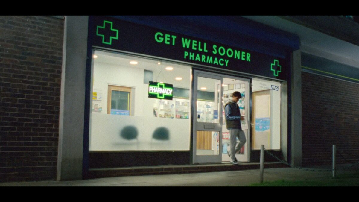 Still from campaign showing "Get Well Soon Pharmacy" sign. NHS England new pharmacy offering