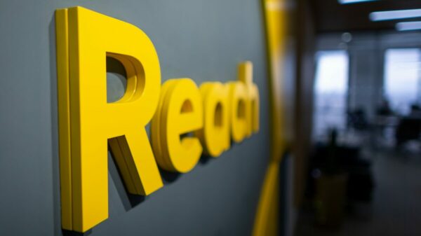 News publisher Reach has seen a drop in advertising revenue significantly impact its pre-tax profits, which have almost halved as result.