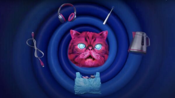Image of Hypnocat surrounded by electricals in a swirly hypnotic style image. A fluffy pink mascot, designed to hypnotise people into recycling their electrical goods, is making a return to television screens.