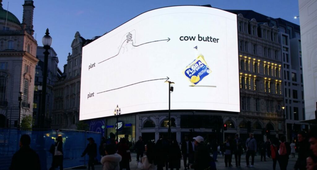 Photo of Flora OOH campaign showing a billboard highlighting that Flora doesn't need to go through a cow. Flora launches latest 'Skip the Cow' spot, suggesting it's just as creamy as 'udder butter'.
