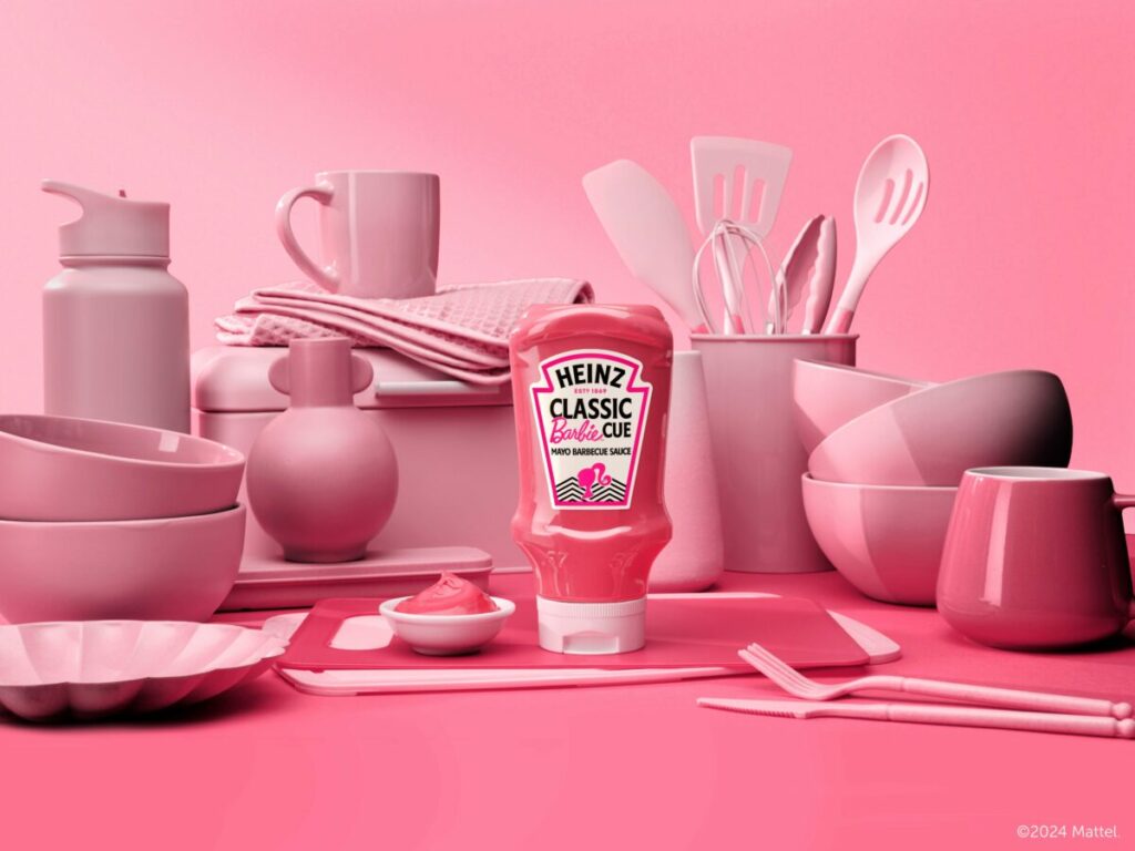 Heinz is joining forces with Mattel to capitalise on Barbie-mania by launching a pink barbie-cue sauce, ahead of both a summer of garden parties and the 65th anniversary of the doll herself. Image shows the pink coloured sauce with Barbie branding on it, on a pink background surrounded by pink utensils.