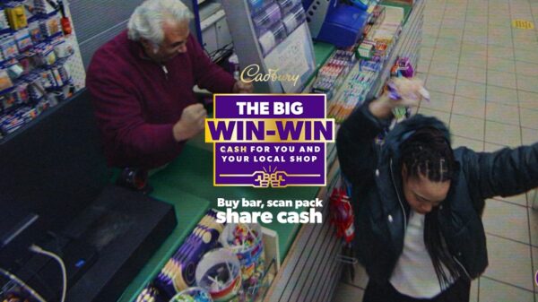 Image shows a still from the new campaign. A girl is dancing and a shopkeeper celebrates as they both win a cash prize. Cadbury is partnering with its agency of record VCCP to relaunch its integrated "The Big Win Win", which spotlights local shops, for the second consecutive year.