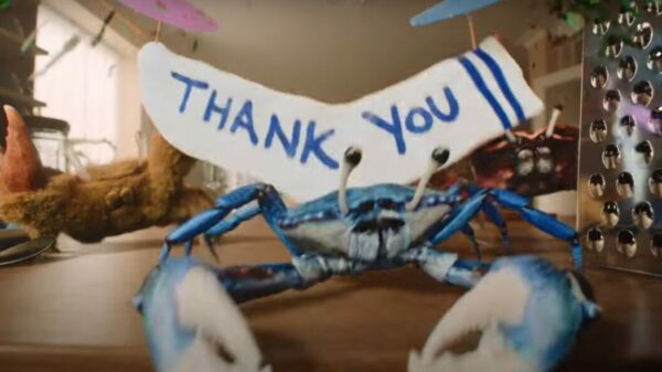 A singing crab stands on a kitchen counter in front of a sign which reads "Thank you". OceanSaver features Bristolian sea shanty group The Longest Johns in its TV debut campaign encouraging people to switch to more environmentally friendly laundry products. 