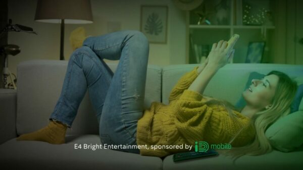 A lady wearing a comfortable sweater and jeans lies on a sofa in a calmly lit room scrolling on her phone. Copy reads "E4 Bright Entertainment, sponsored by iD Mobile". Virtual network operator iD Mobile will sponsor 'E4 Bright Entertainment' from today (May 1), in a landmark new deal secured by Channel 4 Sales.