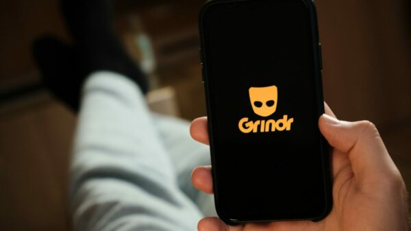 A person using Grindr on a mobile phone, they are lounging. A London lawsuit is to claim that Grindr shared personal information, including the HIV status of users, with ad firms.