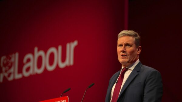 Kier Starmer at a pulpit in front of a red banner which says Labour with the traditional rose. Labour has appointed a dedicated employee to work with influencers to share positive messages about the party.