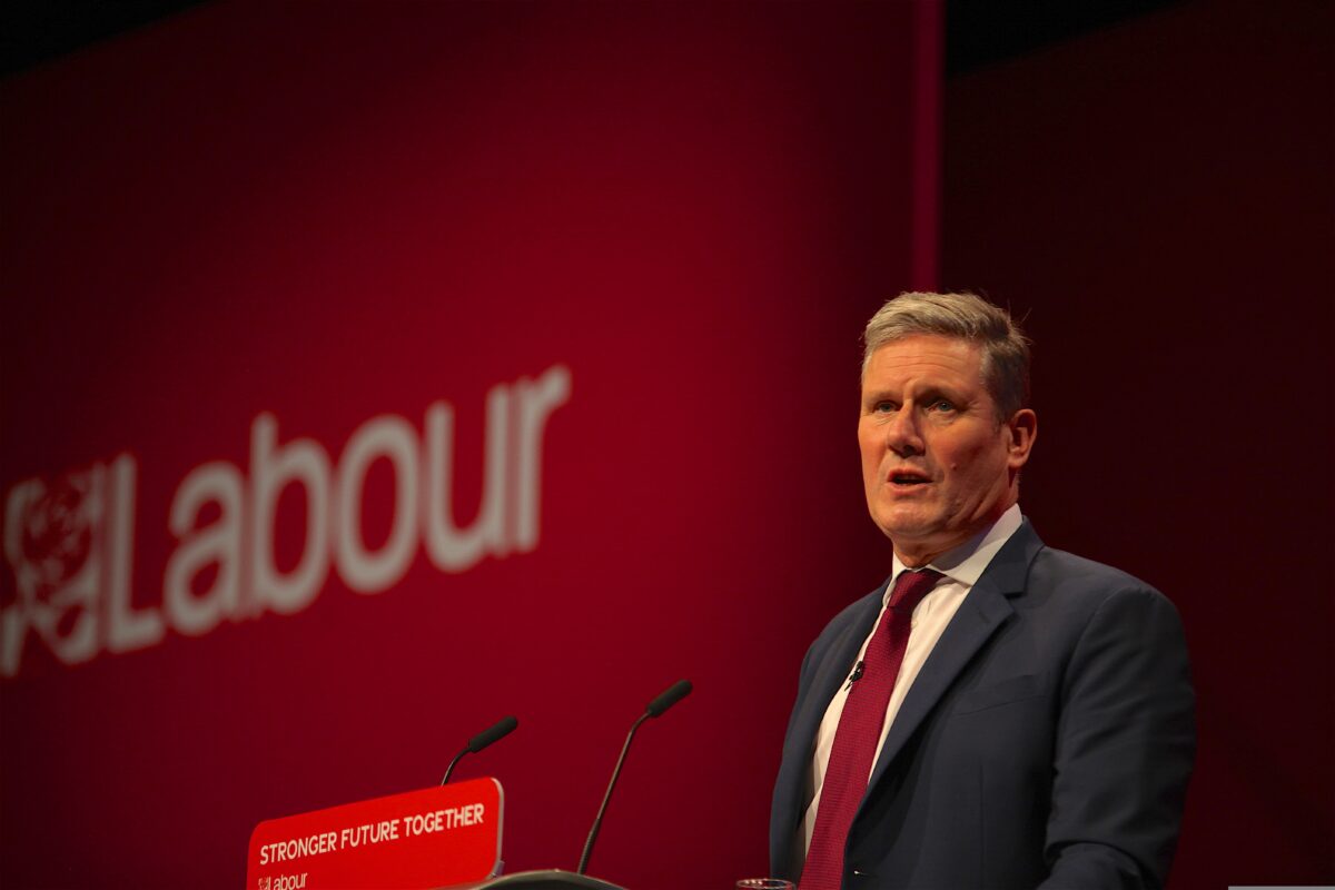 Kier Starmer at a pulpit in front of a red banner which says Labour with the traditional rose. Labour has appointed a dedicated employee to work with influencers to share positive messages about the party.