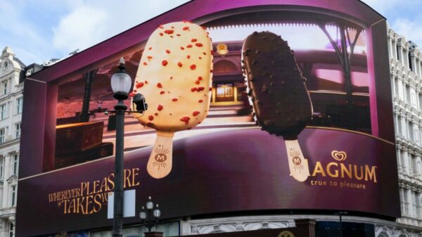 Magnum has launched a new 3D OOH billboard in iconic locations across the UK, including Piccadilly Lights, in order to celebrate this year's new flavour innovations Euphoria and Chill. Image shows a giant billboard with two magnum flavours the pink lemondade euphoria one and magnum's "chill" blueberry cookies flabour which is chocolate. The billboard marks part of the largest campaign in the UK.