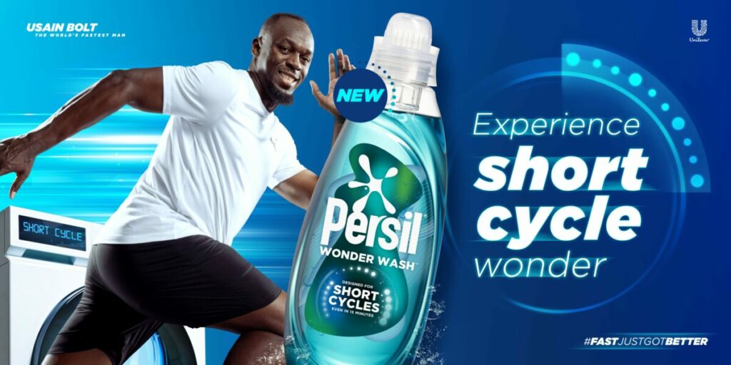Unilever brand Dirt Is Good is starring Usain Bolt in a multi-million pound marketing campaign to support the launch of its new Persil Wonder Wash product. The image shows Usain Bolt preparing to sprint on a green background with the phrase "Experience Short Cycle Wonder". Behind him is a laundry that reads "Short Cycle" on the settings screen. In the left hand corner is the phrase "Usain Bolt the world's fastest man"