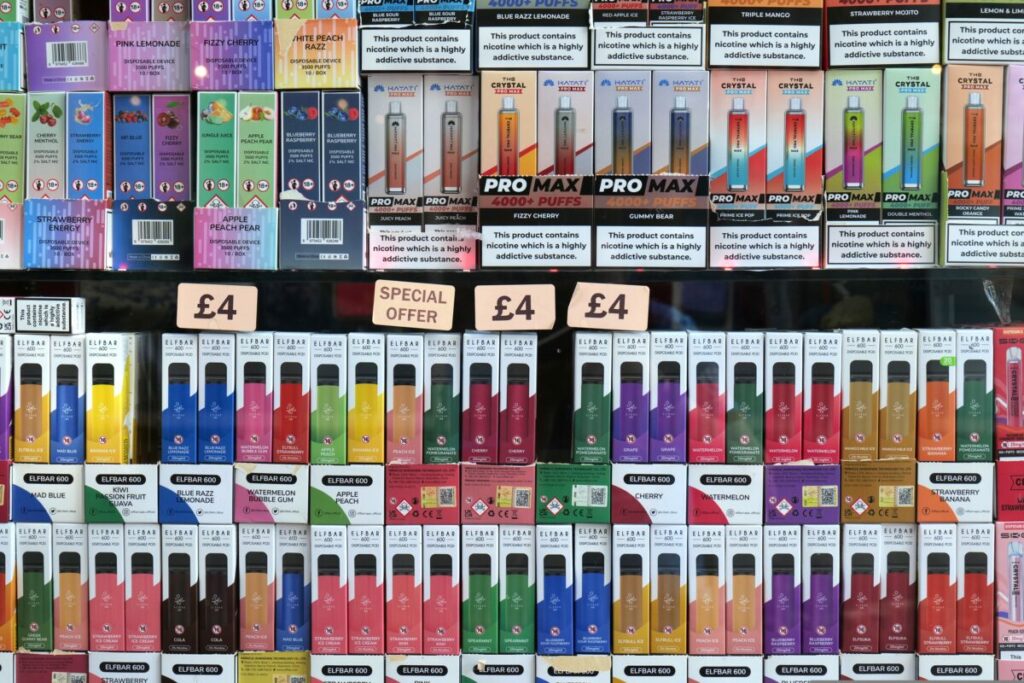 Speaking on Radio 4's Today programme this morning (April 16), chief medical officer Professor Chris Whitty called the way vapes are advertised "completely unacceptable", and expressed support for measures like plain packaging. Image shows brightly coloured vapes, with a n array of sweet flavours for sale for cheap prices on a stall.