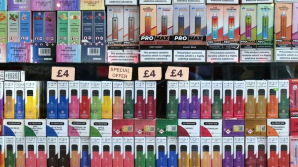 Speaking on Radio 4's Today programme this morning (April 16), chief medical officer Professor Chris Whitty called the way vapes are advertised "completely unacceptable", and expressed support for measures like plain packaging. Image shows brightly coloured vapes, with a n array of sweet flavours for sale for cheap prices on a stall.