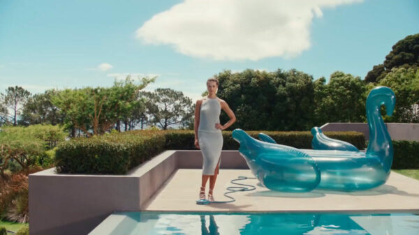 A model poses next to a cool blue inflatable by the pool, in a fitted summery white dress. M&S has kicked off its summer wear campaign with a series of effortlessly poolside cool imagery, with this season's theme being "sun, sea and stylish wardrobe".