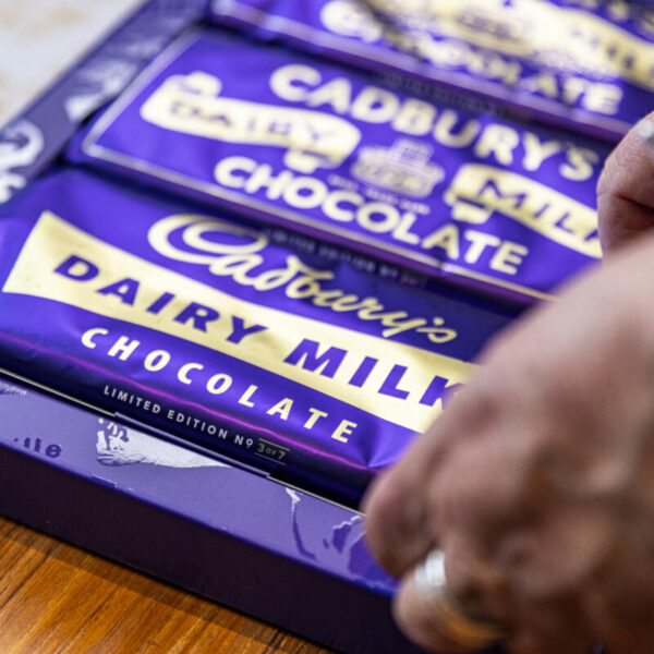 A person with a silver ring places down a box of Cadbiry bars with vintage packaging, rejigging the memories of years gone by. Cadbury and Alzheimer's UK have distributed 4,000 memory bar boxes to people living with dementia and their loved ones to coincide with Dementia Action Week (13 May to 19 May).