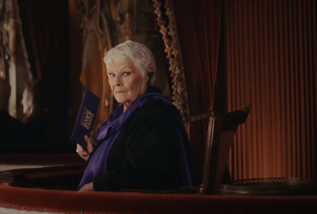 Judi Dench in a premium seat at the opera, holding her Moneysupermarket deal. Money Supermarket has shared its latest ad directed by Shakespeare In Love director John Madden, starring Judi Dench at the opera.