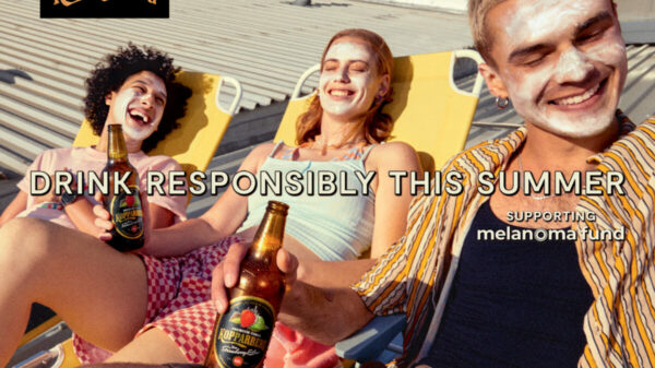 Young people slathered in suncream on sun loungers drinking in the sun. Koppaberg has partnered with charity Melanoma Fund, in order to encourage consumers to drink responsibly in the sun this summer.