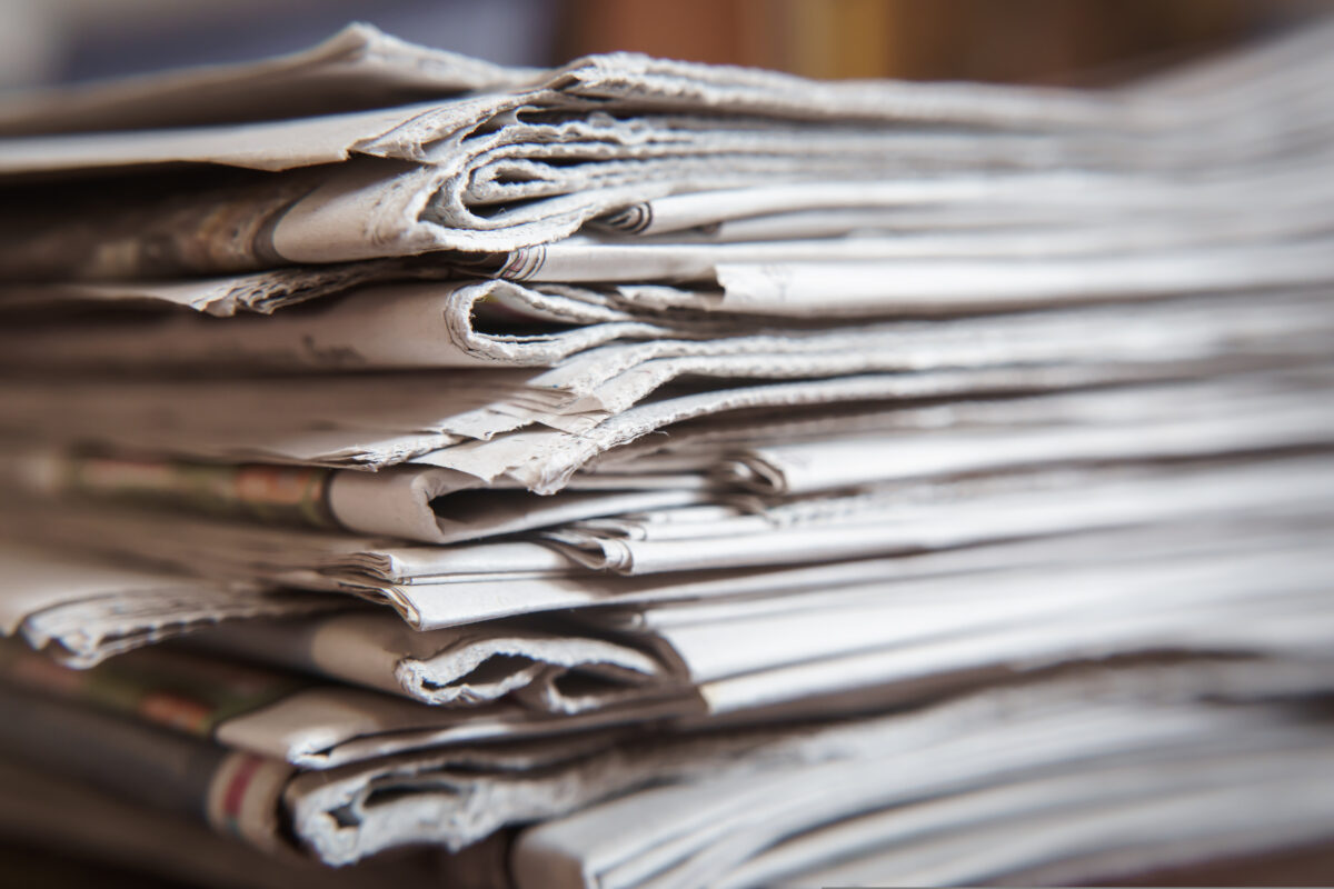 Stack of newspapers. British newspaper groups have warned Apple that any move to impose an "eraser" tool to block advertisers would put the journalism profession at financial risk.