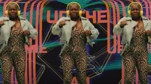 Hype Gran wears a leopard print outfit and a jean jacket with yellow headphones, she concentrates as she jumps up and down feeling the beat. Watch: Jam Shed wine signs Hype Gran to "pump up" passion