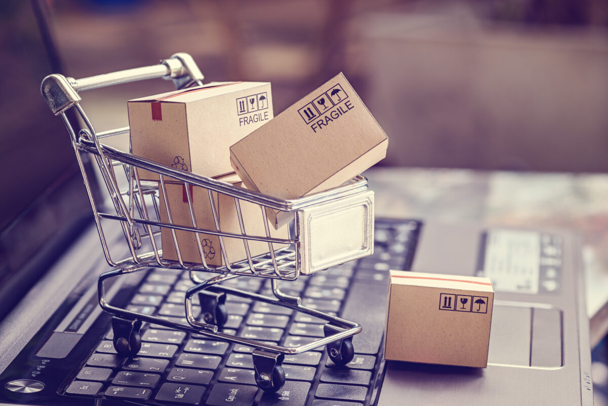 Mini shopping trolley on a laptop keyboard to represent the click and spend of e-commerce. Klarna has leveraged AI to increase the number of campaigns it puts out, all while cutting its sales and marketing spend by 11% in Q1 2024.