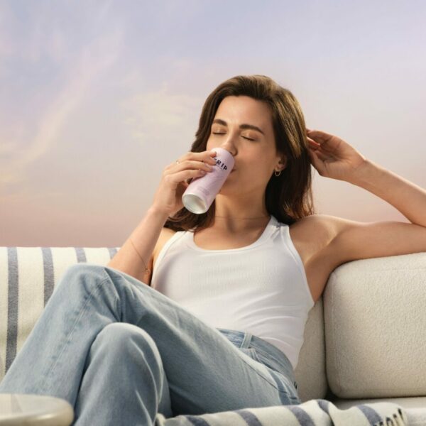A woman lounges back on a stylish looking sofa in comfortable bagging jeans in calming surroundings, she is sipping on a Trip CBD drink. Trip has launched its first ever £multi-million ad campaign in an effort to showcase how the CBD-infused drink can help viewers find their calm.