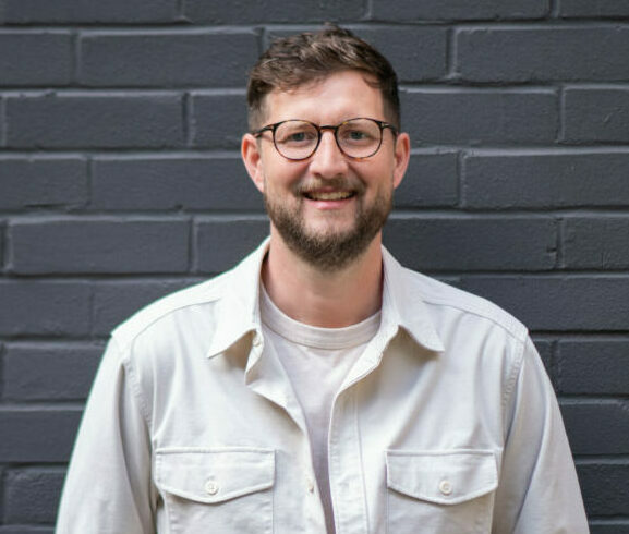 Image of Joe Bruce in front of black brick wall. Above + Beyond has snapped up Wieden + Kennedy creative director Joe Bruce to act as its new executive creative director.