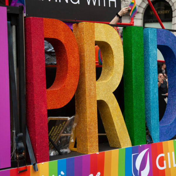 A float reads Pride in the pride rainbow colours.