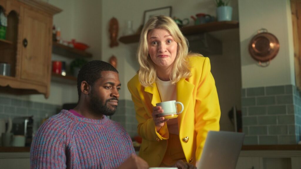 A man searches for savings deals as The Whisperer approaches tea and fresh deals in hand. Popular savings site VoucherCodes.co.uk is set to return to television for the first time in 12 years, with a playful new character entitled The Whisperer at the helm.
