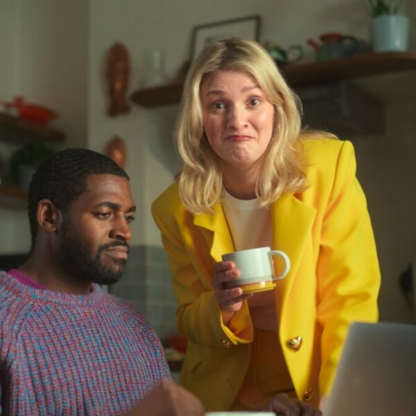A man searches for savings deals as The Whisperer approaches tea and fresh deals in hand. Popular savings site VoucherCodes.co.uk is set to return to television for the first time in 12 years, with a playful new character entitled The Whisperer at the helm.